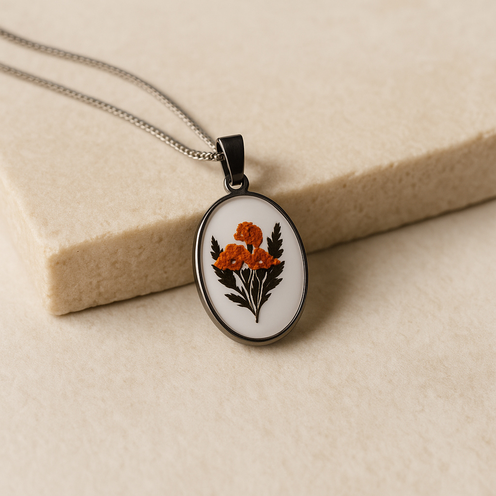 Nature-inspired pendant featuring orange bloom and green foliage