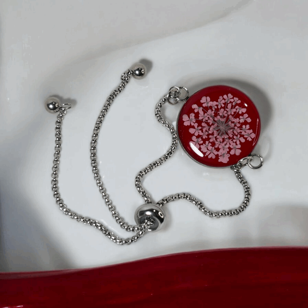 Handmade red resin bracelet with preserved pink flower